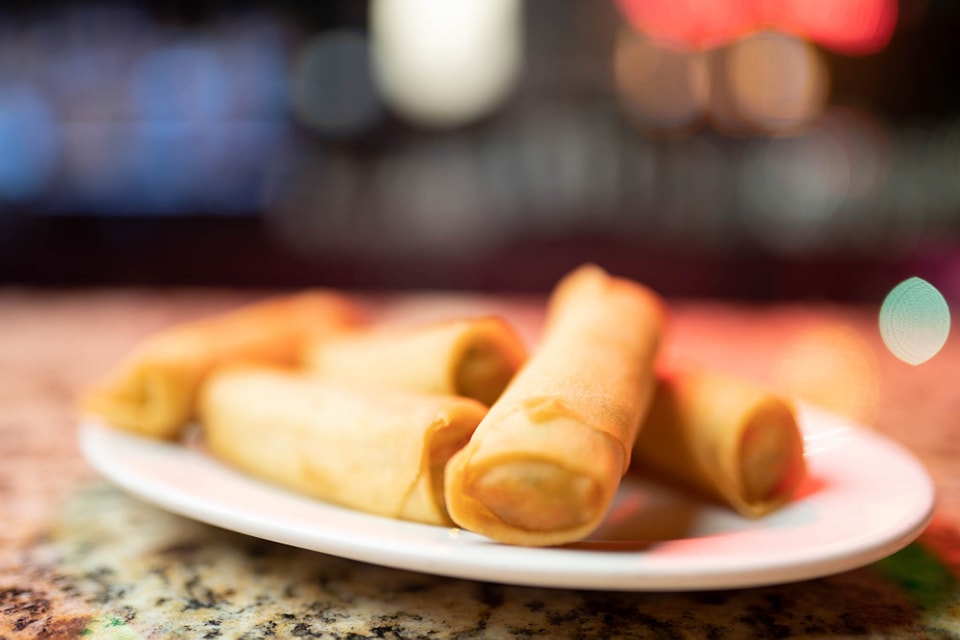 Golden spring rolls served on a white plate